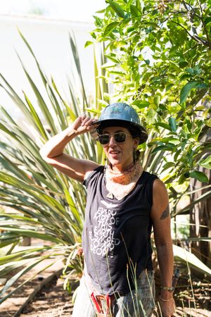 Woman in hard hat outside with cactus in the background