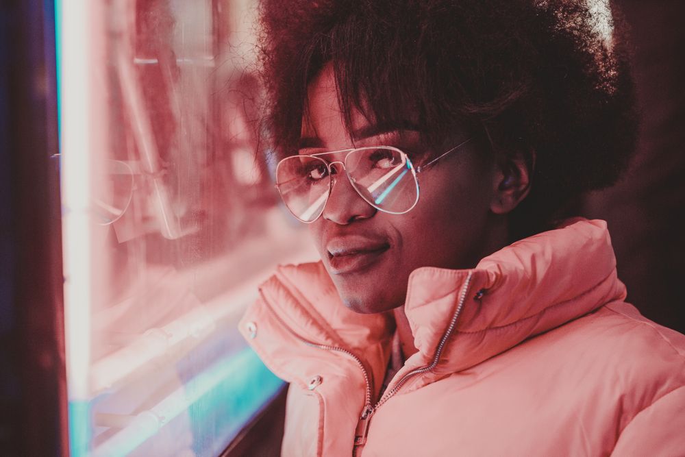 Black woman standing on night city street