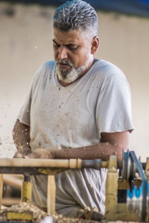 Man using woodworking machine at workplace