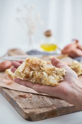 Anonymous person holding onion tart