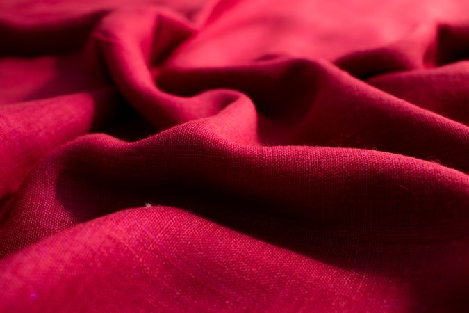 CLose up Red fabric wavy crumpled background texture.