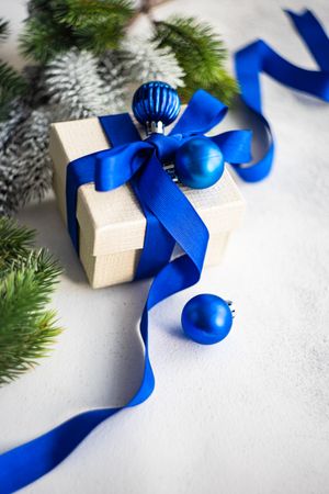 Christmas present with blue ribbon and baubles
