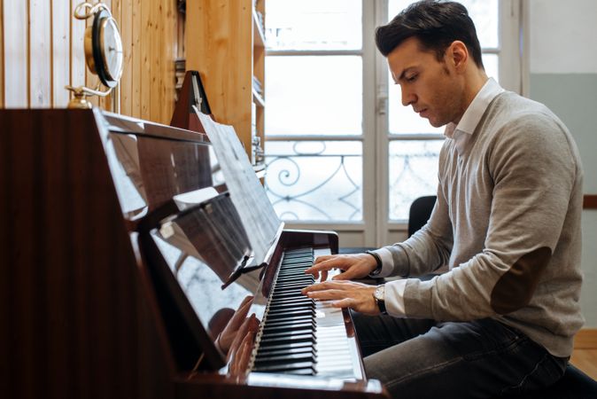 Man playing piano in studio