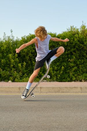 Brave boy jumping with skateboard