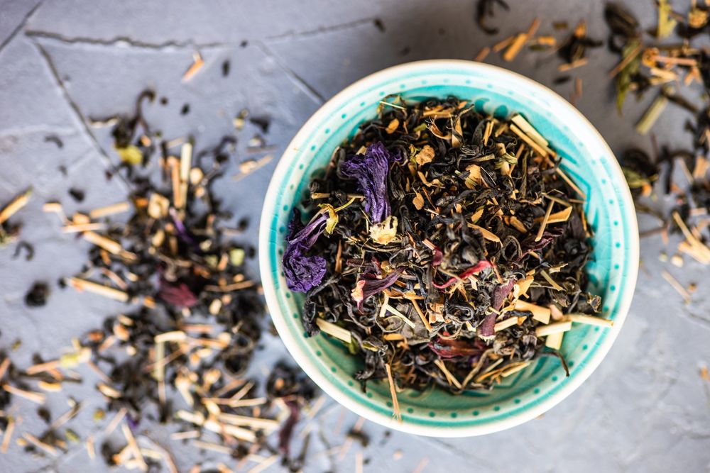 Top view of floral tea in a teal bowl