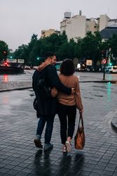 Young couple walking on wet street