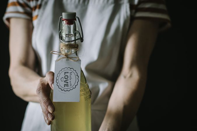 Female with bottle of elderflower syrup