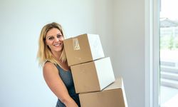 Woman carrying moving boxes