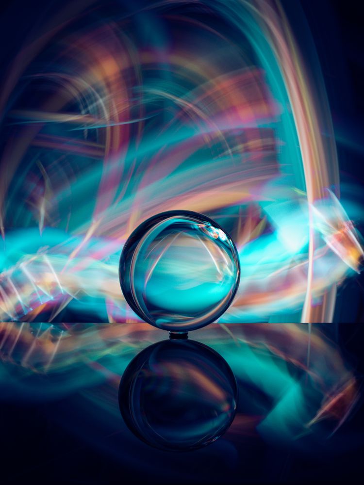 Crystal ball on board near abstract shines