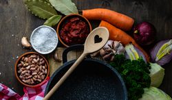 Top view of ingredients for hearty soup surrounding pan