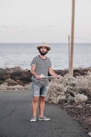 Male traveler standing with map