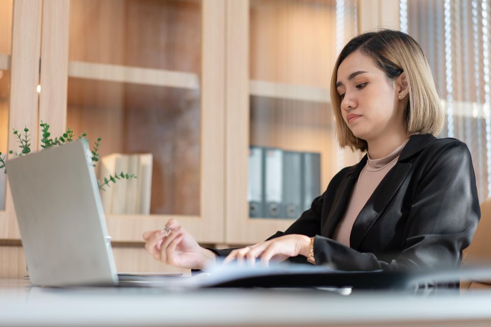 Asian Female manager working on project using computer laptop