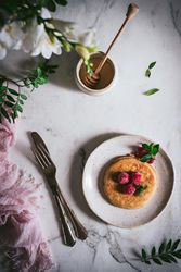 Pancake with fresh raspberry on plate