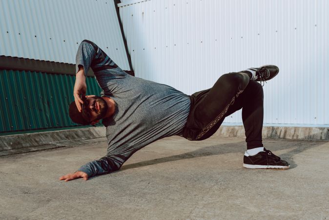 Man performing handstand near wall