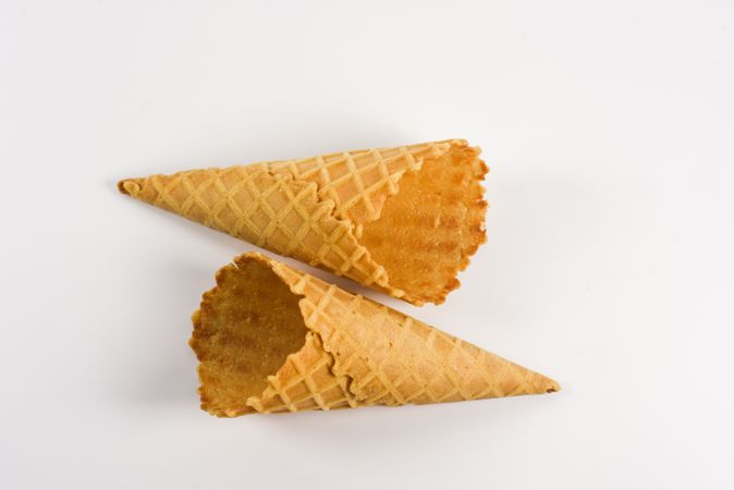 Two waffle cones lying on table