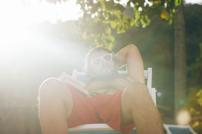 Man chilling on deckchair in sunshine