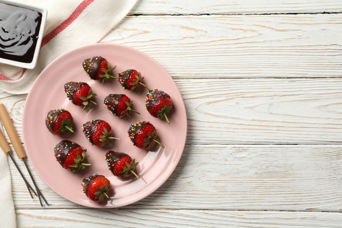 Chocolate fondue. Strawberry in chocolate on wooden background