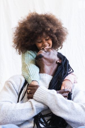 Loving daughter gently embracing cheerful father