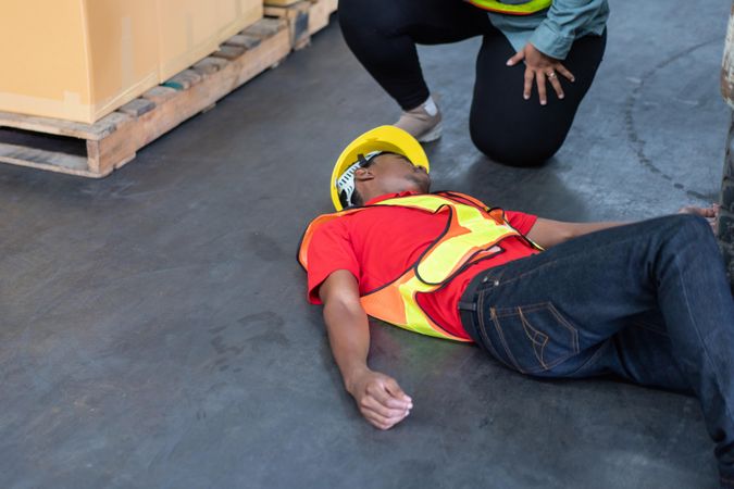 Black male in PPE gear passed out on storeroom floor