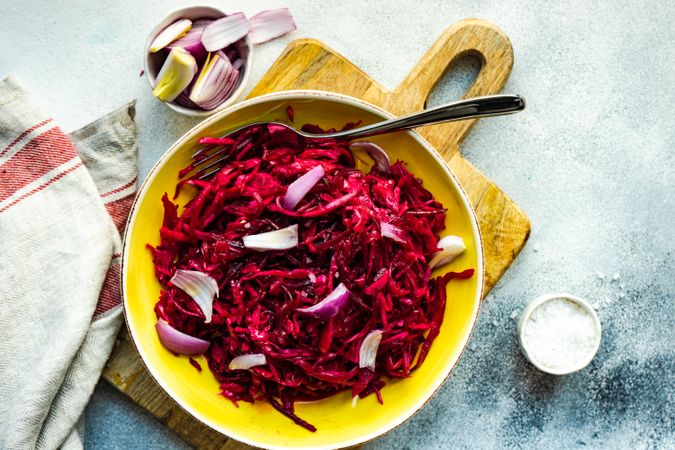 Top view of healthy cabbage and beetroot salad yellow bowl