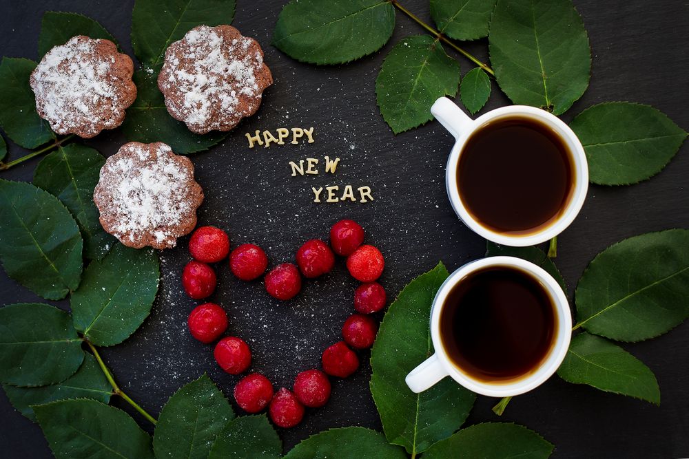 inscription of new year on a board with cupcake