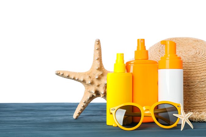 Summer vacation accessories on wooden table isolated on neutral background. Happy holidays