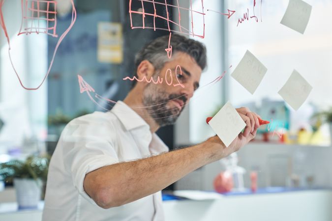 Serious man working on project in office