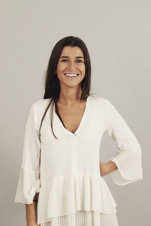 Cheerful young woman celebrating success in studio