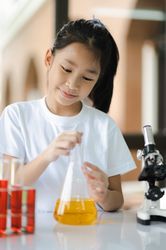 Asian girls having fun experimenting with science.