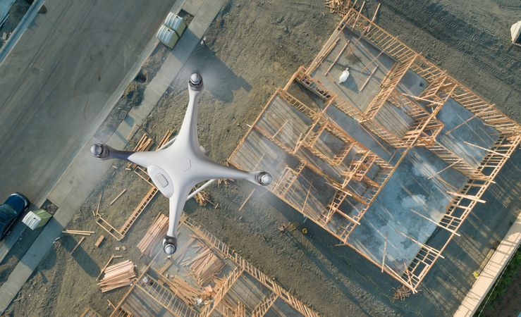 Unmanned Aircraft System Quadcopter Drone UAV In The Air Over Construction Site.