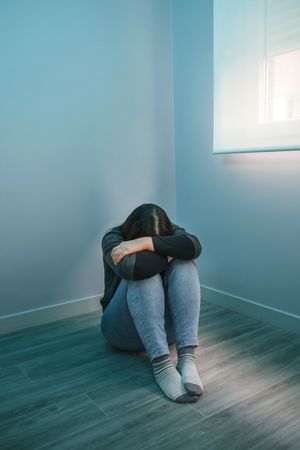 Unrecognizable desperate woman with head down