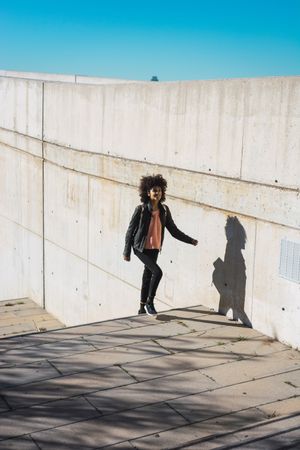 Black woman walking down the street.