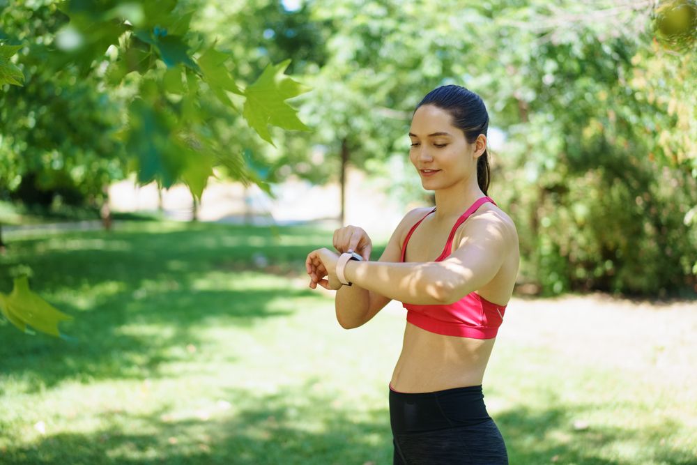 Woman checking her watch in park
