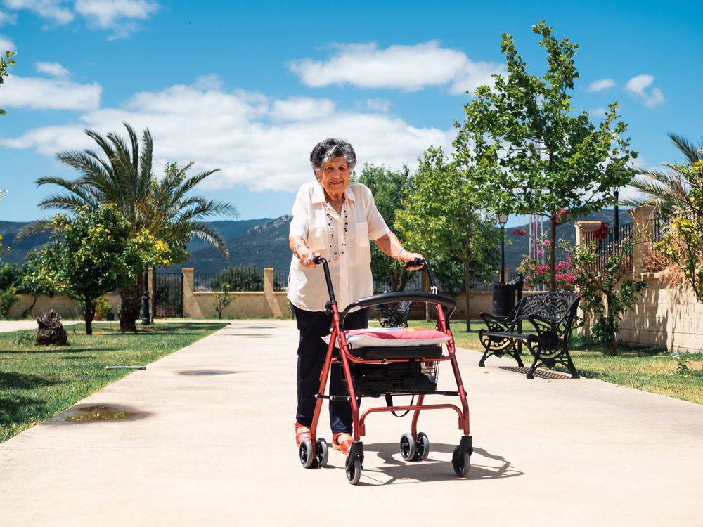 Older woman with walker on street