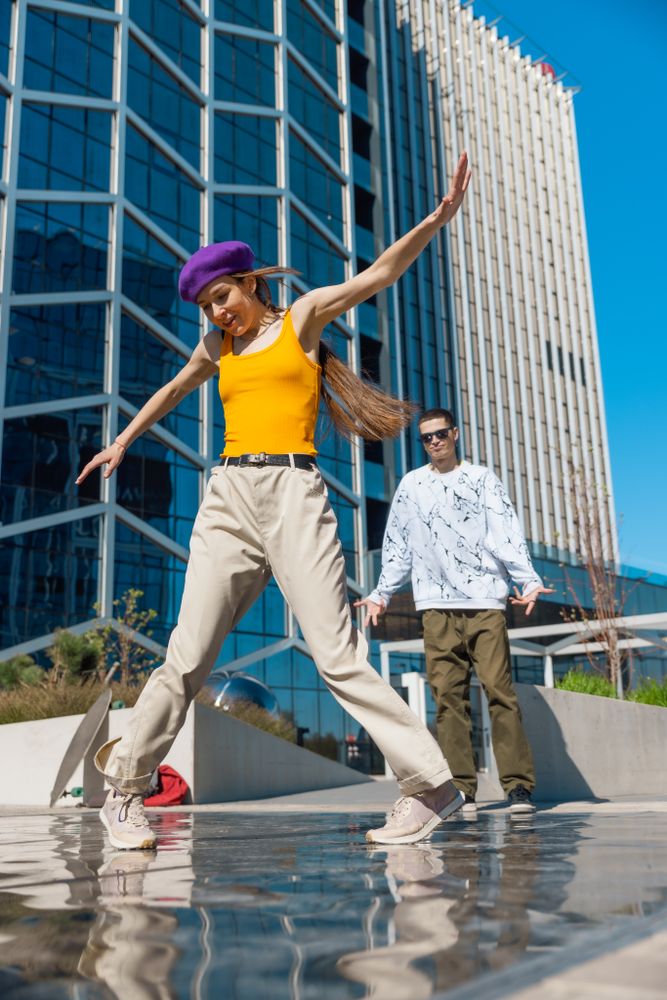 Vertical Screen: Young And Stylish Female Hip-Hop Dancer Freestyling On City Street In the Circle Of Fashionable Friends.