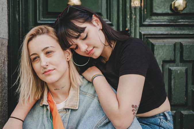 Lesbian couple sitting near door