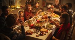 Christmas Celebration at Home with Multicultural Group of Loved Ones Enjoying a Turkey Dinner.