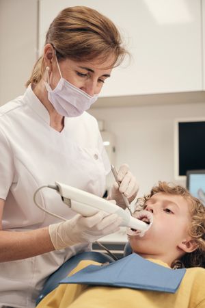 Dentist woman using intraoral scanner for getting 3d digital casts