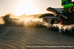 Dirt biker riding on sand dunes 5znVn5