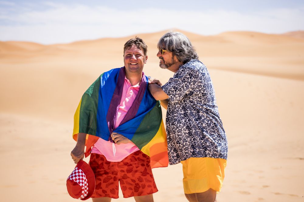 Excited gay couple in desert