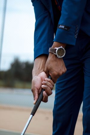 Cropped image of man in blue suit holding golf club