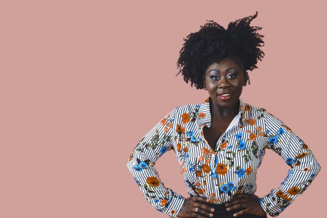 Studio shot of confident Black woman in floral print shirt