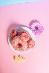 Pink doughnuts with banana shape candies and flower