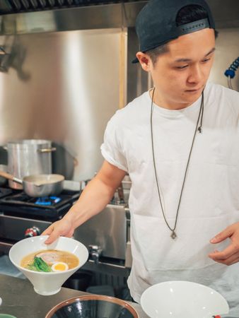 Asian chef with served bowls of ramen