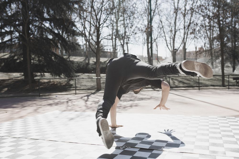 Man dancing break dance in park