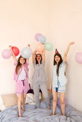 Family celebrating with balloons, joyous party at home