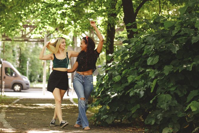 Cheerful friends walking in park