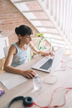 Woman working at laptop at home desk