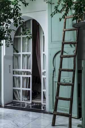 Ladder near green Arabic building