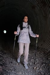Positive Hispanic woman walking in tunnel